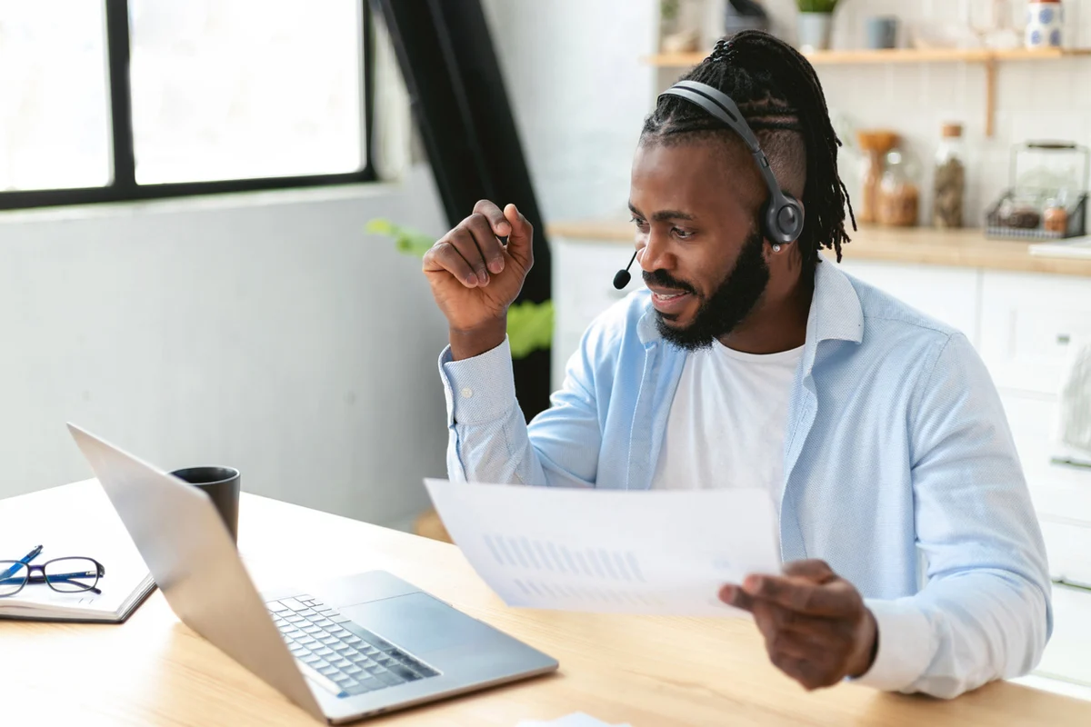 Self-employed remote sales agent working from home with a laptop and phone